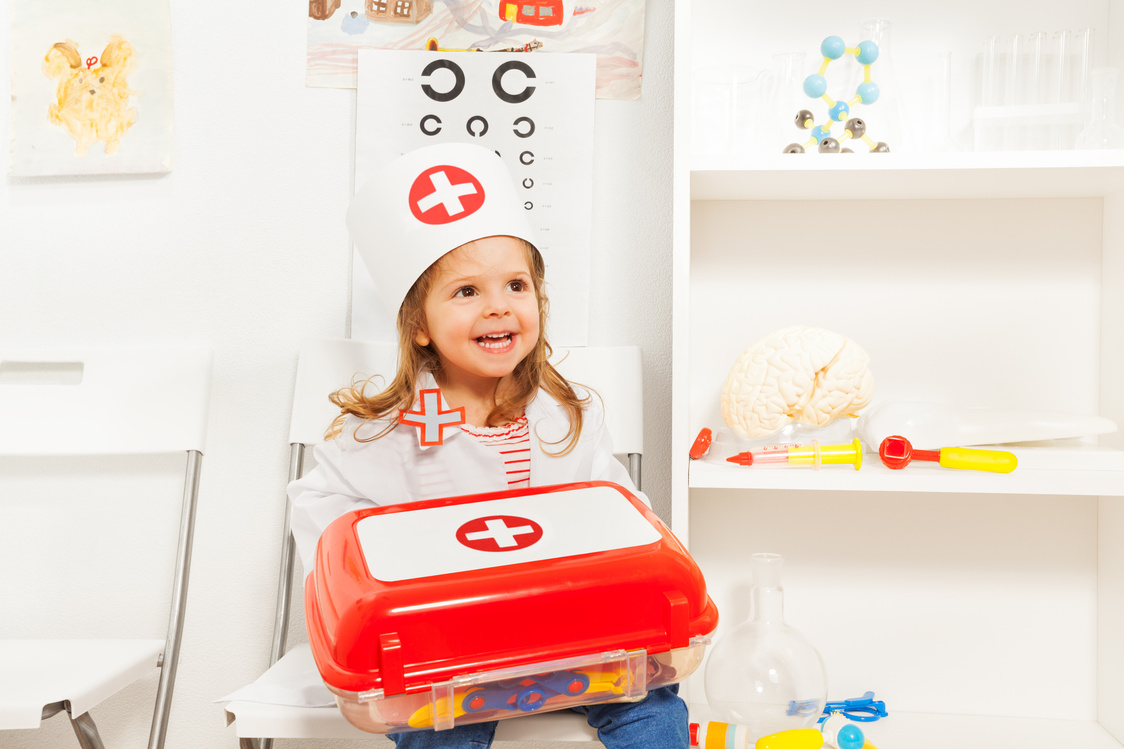 Girl Dressed like Doctor with Toy First-Aid Chest